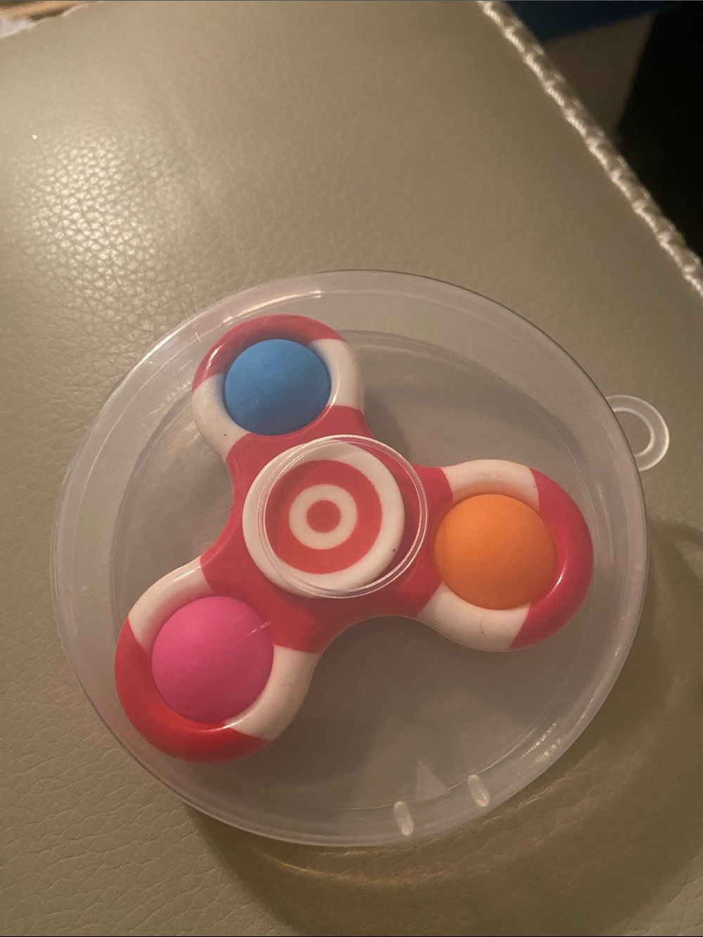 Red and White Kids Spinner Toy with Pink, Blue, and Orange Buttons